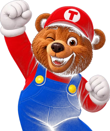 Theo, o urso mascote do Brava Park Fest, de boné vermelho, macacão azul e luvas brancas, comemorando
